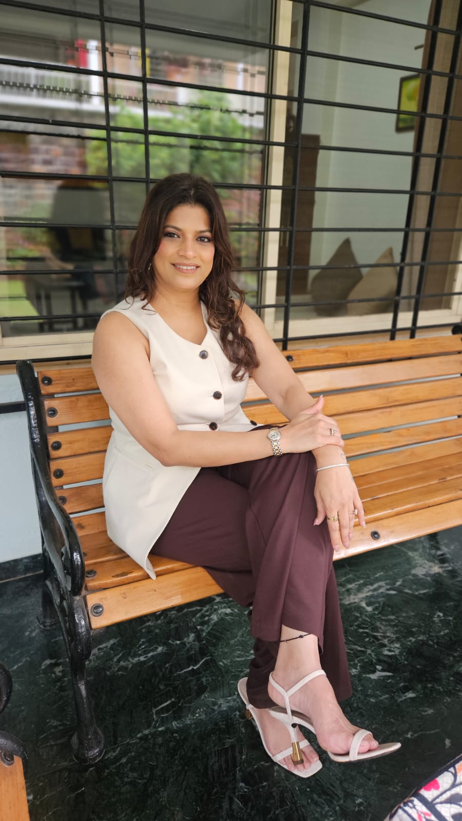 Abhilasha Lonari seated on a wooden bench in a composed portrait