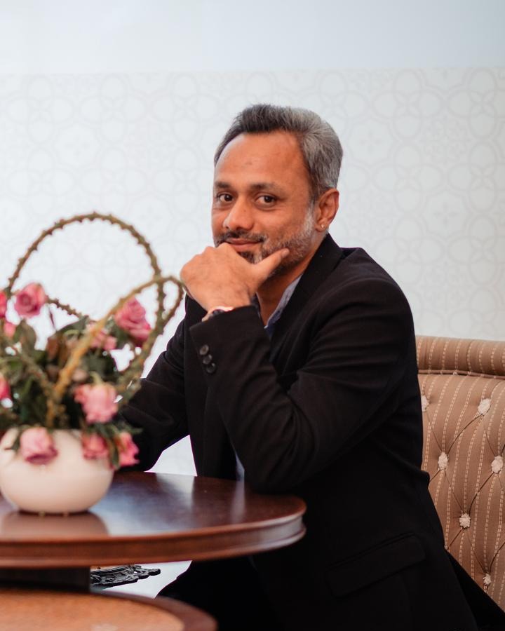 Close-up portrait of Vibhor Somani seated at a table